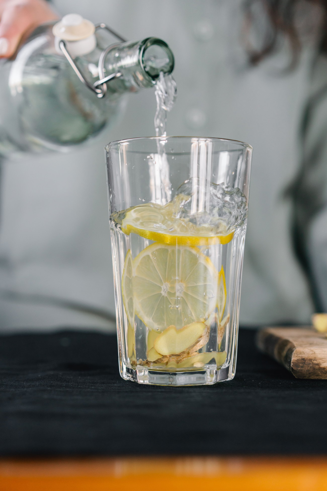 Water poured over lemon slices in a tall glass