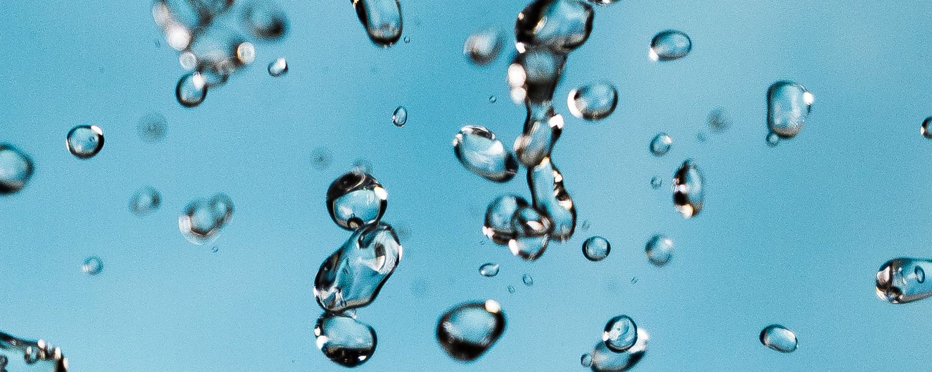 Droplets suspended in mid-air above water