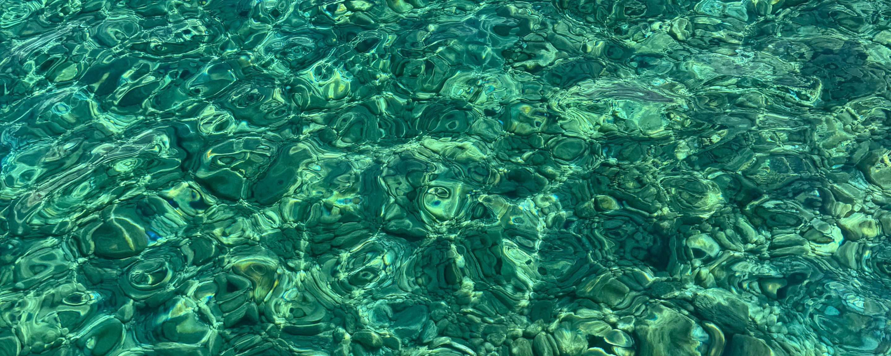 Clear water running over pale stone